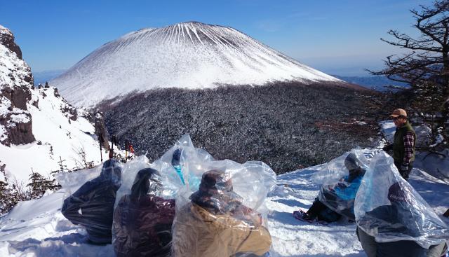 雄大な浅間山を見ながらの休憩。宿で販売しているおおきなビニール袋を被り休憩する姿をご覧下さい。温かくて、展望もＯＫのナイスアイデア！！