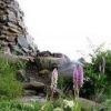 石神井ケルン　（八方山ケルン　標高１９７４ｍ）　ケルンの周囲を高山植物が彩っています。淡紅色と白花系のテガタチドリ、イワシモツケの花が咲いています