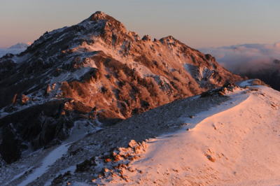 燕岳は雪化粧。朝日を受け赤く染まる 