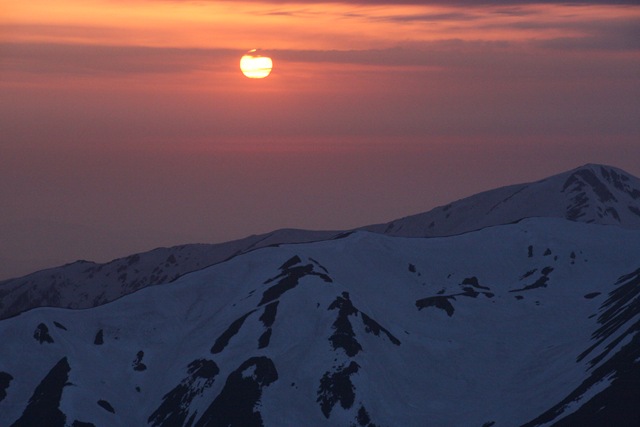 北アルプスの稜線に夕日が沈む
