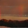 ヒュッテの窓から見える鷲羽岳の左とワリモ岳～水晶岳の稜線から２本の鮮やかな虹が出現。